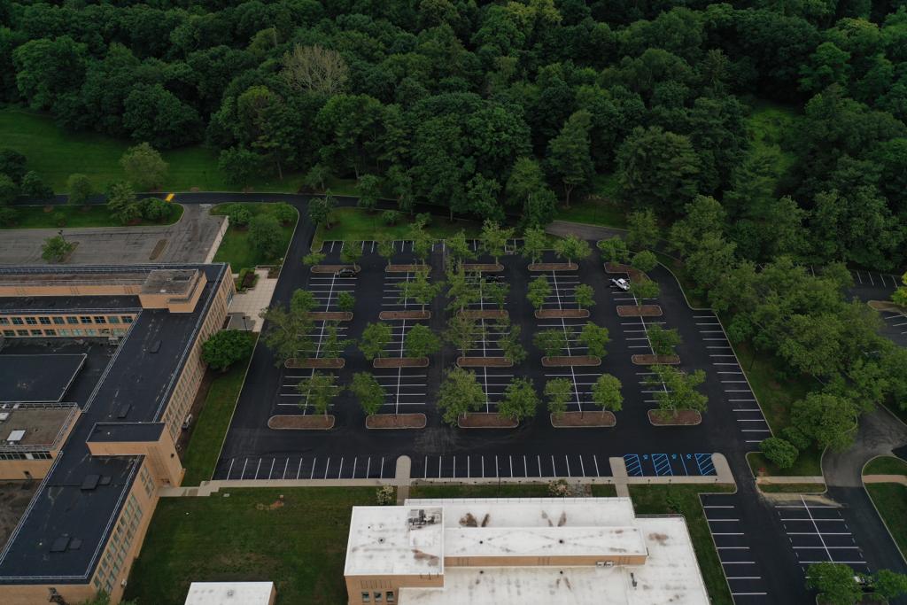 Aerial view of a resurfaced commercial asphalt parking lot